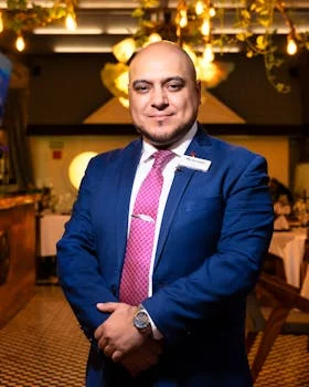 restaurant manager in professional attire smiling