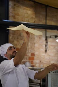 pizza chef tossing dough with expertise